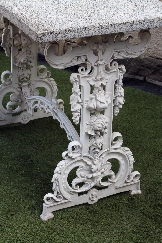 A VICTORIAN CAST IRON PUB TABLE of oblong form with composite stone top on pierced and moulded Image