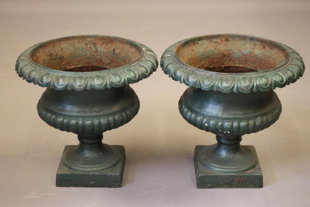 A PAIR OF CAST IRON URNS of half fluted campana form with deeply moulded ovolu rim Image