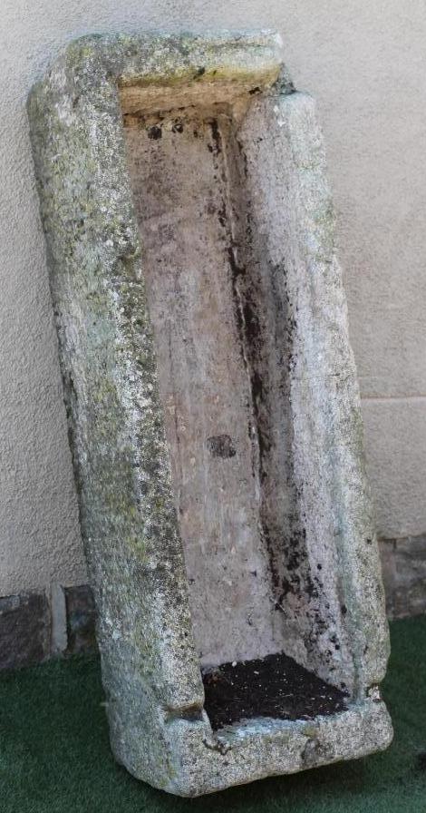 A LARGE GRANITE TROUGH of rough hewn narrow oblong form with mildly tapering sides Image
