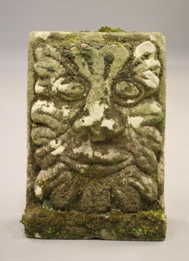 A CARVED SANDSTONE WALL PLAQUE modelled as a grotesque mask Image