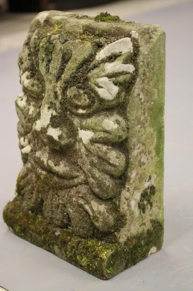 A CARVED SANDSTONE WALL PLAQUE modelled as a grotesque mask Image