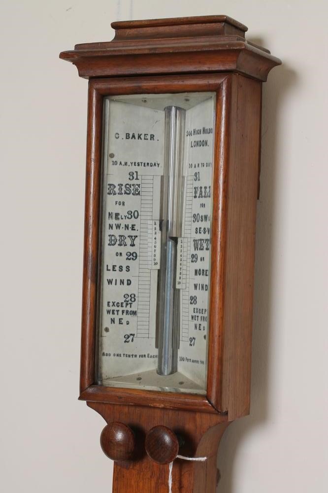 AN OAK CASED STICK BAROMETER by C. Baker Image