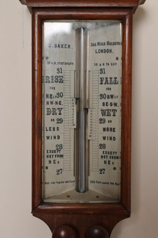 AN OAK CASED STICK BAROMETER by C. Baker Image