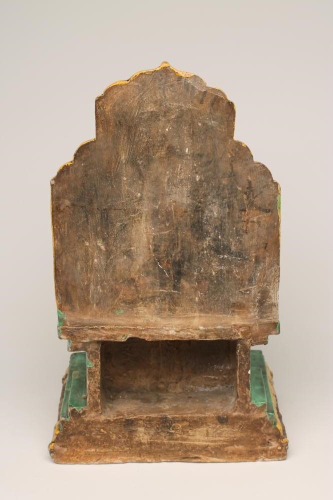 A CHINESE EARTHENWARE FIGURE modelled as a dignitary seated on a flower moulded throne on a stepped Image