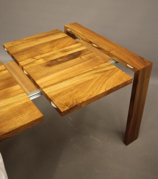 A WALNUT EXTENDING TABLE by Heals of London Image