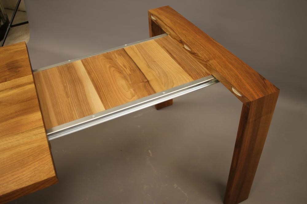 A WALNUT EXTENDING TABLE by Heals of London Image