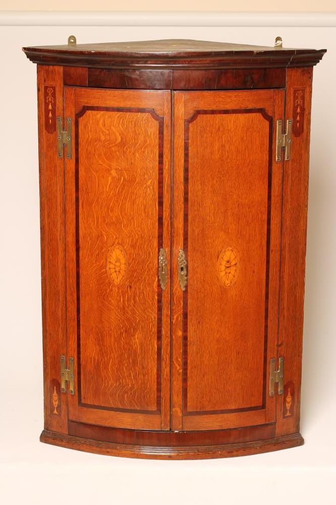 A GEORGIAN OAK AND MAHOGANY CORNER CUPBOARD Image