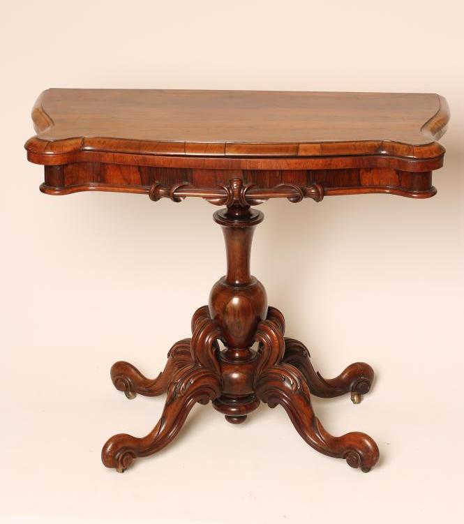 A VICTORIAN ROSEWOOD FOLDING CARD TABLE of oblong serpentine form Image