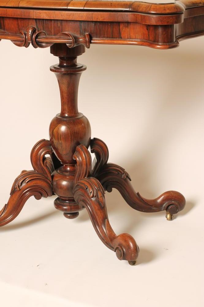 A VICTORIAN ROSEWOOD FOLDING CARD TABLE of oblong serpentine form Image