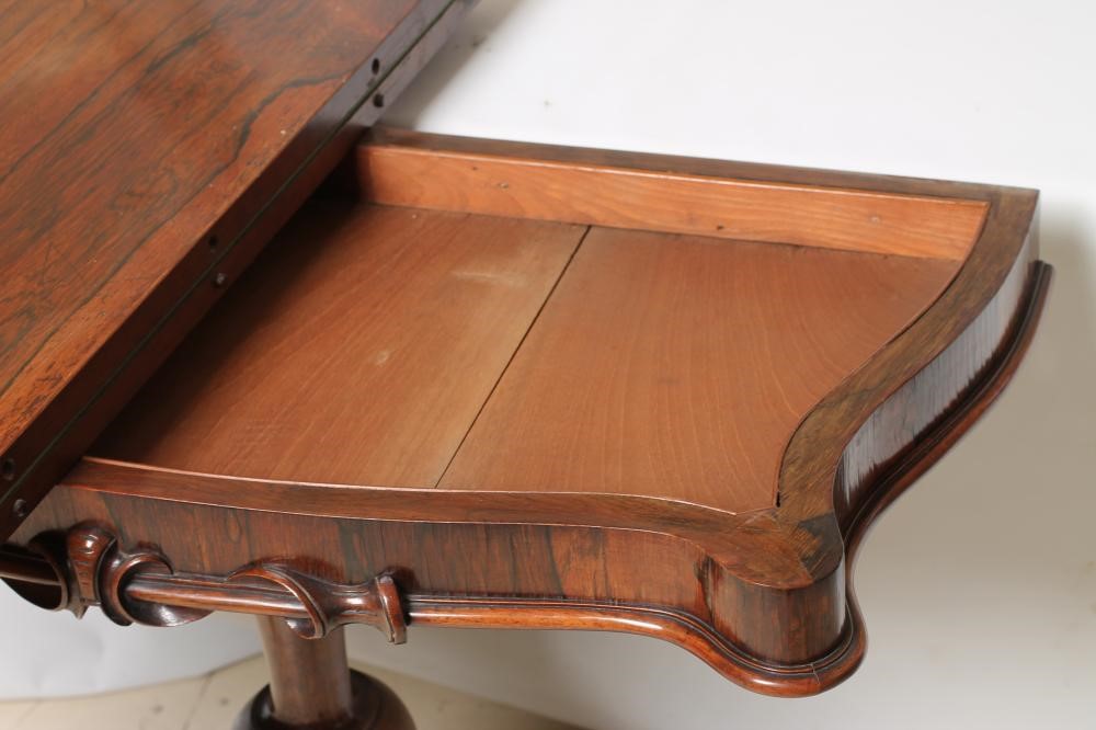 A VICTORIAN ROSEWOOD FOLDING CARD TABLE of oblong serpentine form Image