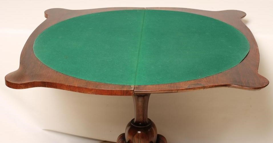A VICTORIAN ROSEWOOD FOLDING CARD TABLE of oblong serpentine form Image