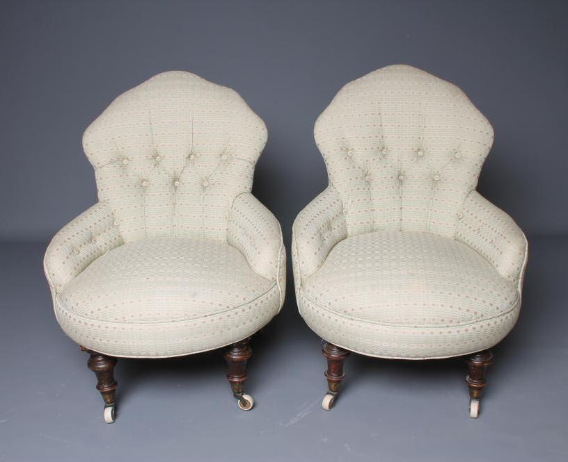 A PAIR OF VICTORIAN WALNUT FRAMED NURSING CHAIRS button upholstered in a pale green weave Image