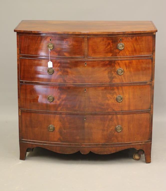 A REGENCY MAHOGANY CHEST of bowed form with ebony stringing Image