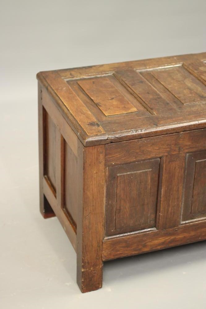 AN OAK PANELLED COFFER Image