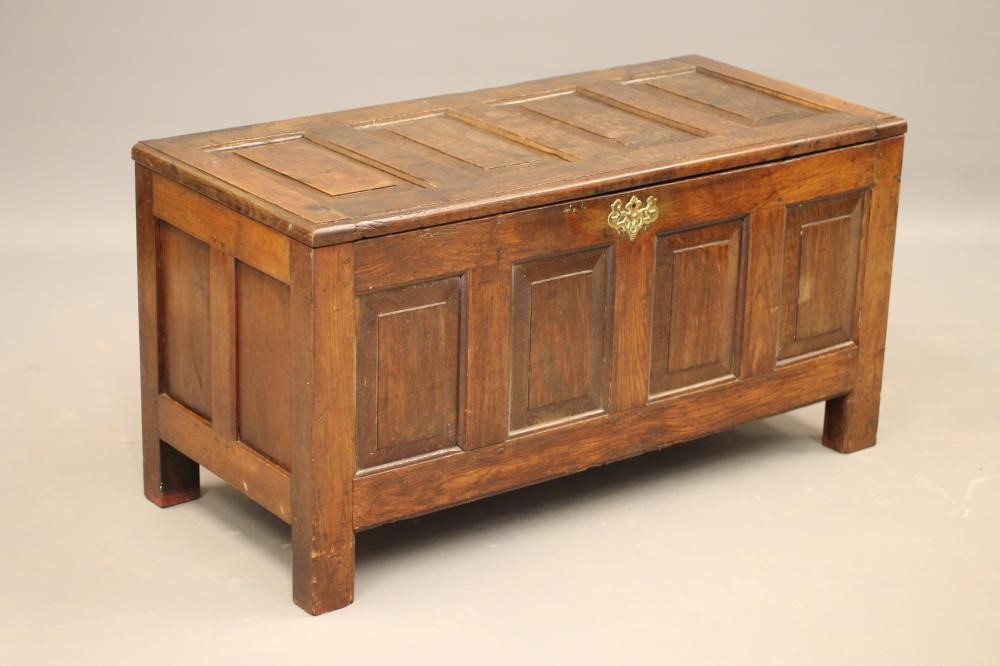 AN OAK PANELLED COFFER Image