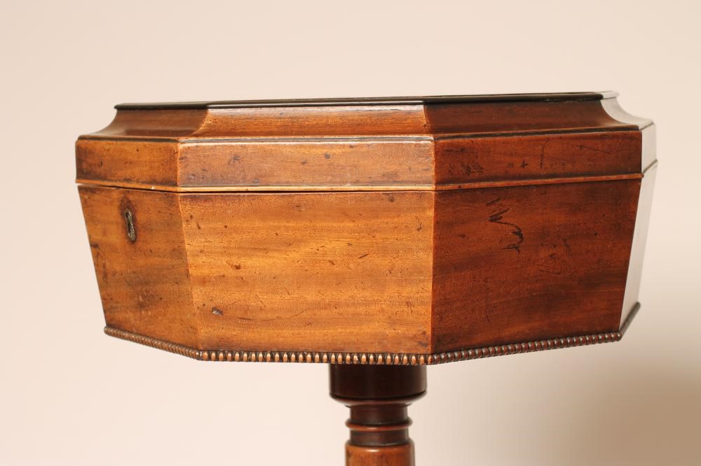 A REGENCY MAHOGANY TEAPOY of octagonal form with ebony stringing and beaded edging Image