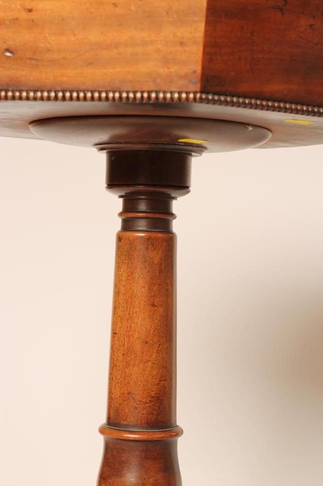 A REGENCY MAHOGANY TEAPOY of octagonal form with ebony stringing and beaded edging Image