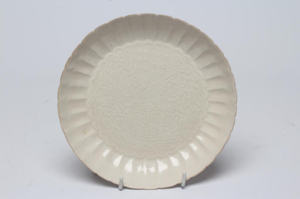 A CHINESE WHITE GLAZED PORCELAIN DISH of fluted circular form centrally carved with a crane in Image