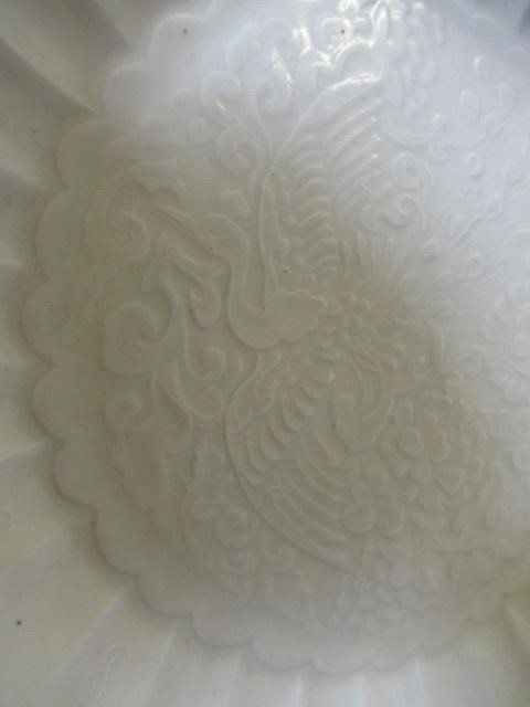 A CHINESE WHITE GLAZED PORCELAIN DISH of fluted circular form centrally carved with a crane in Image