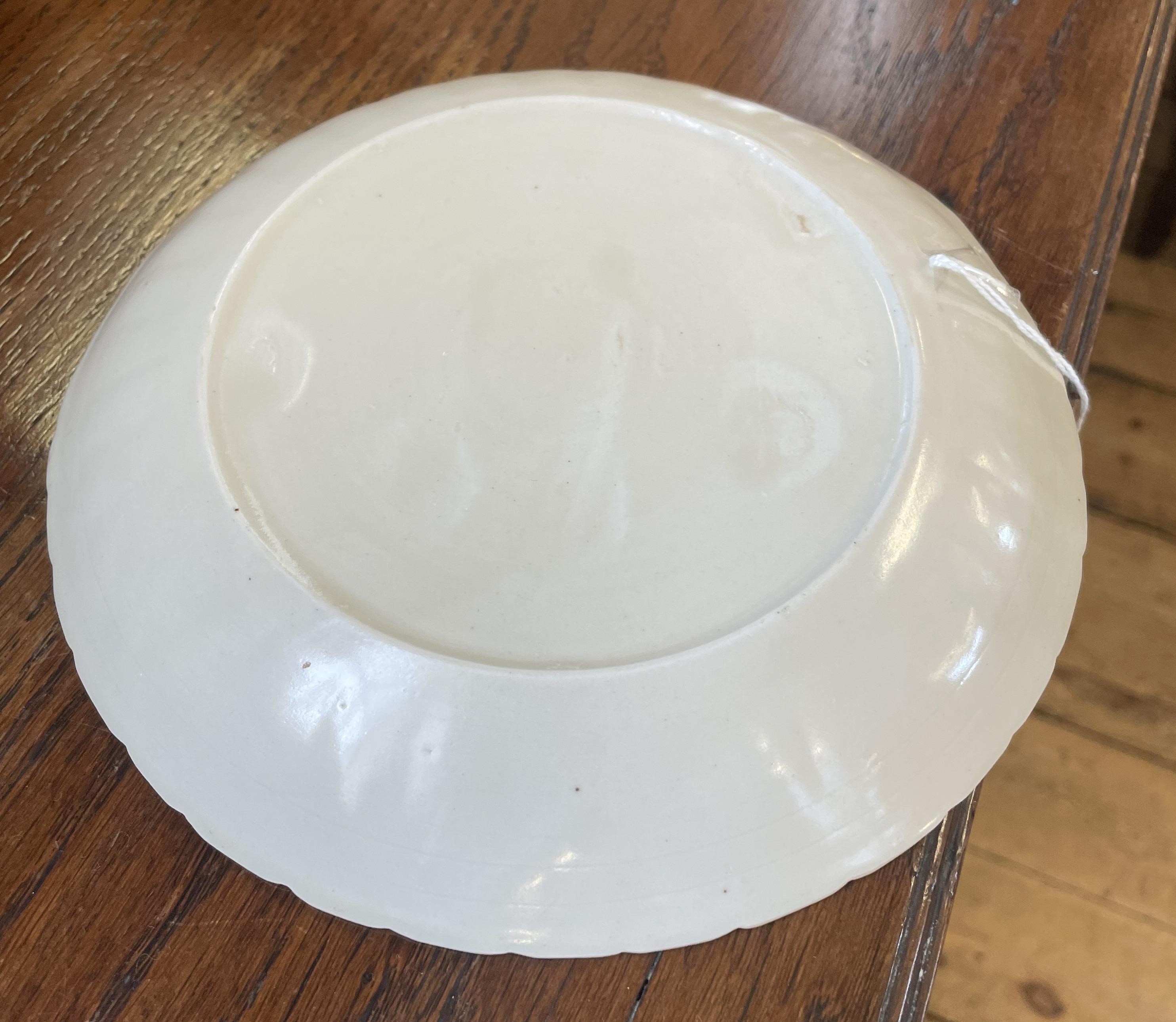 A CHINESE WHITE GLAZED PORCELAIN DISH of fluted circular form centrally carved with a crane in Image