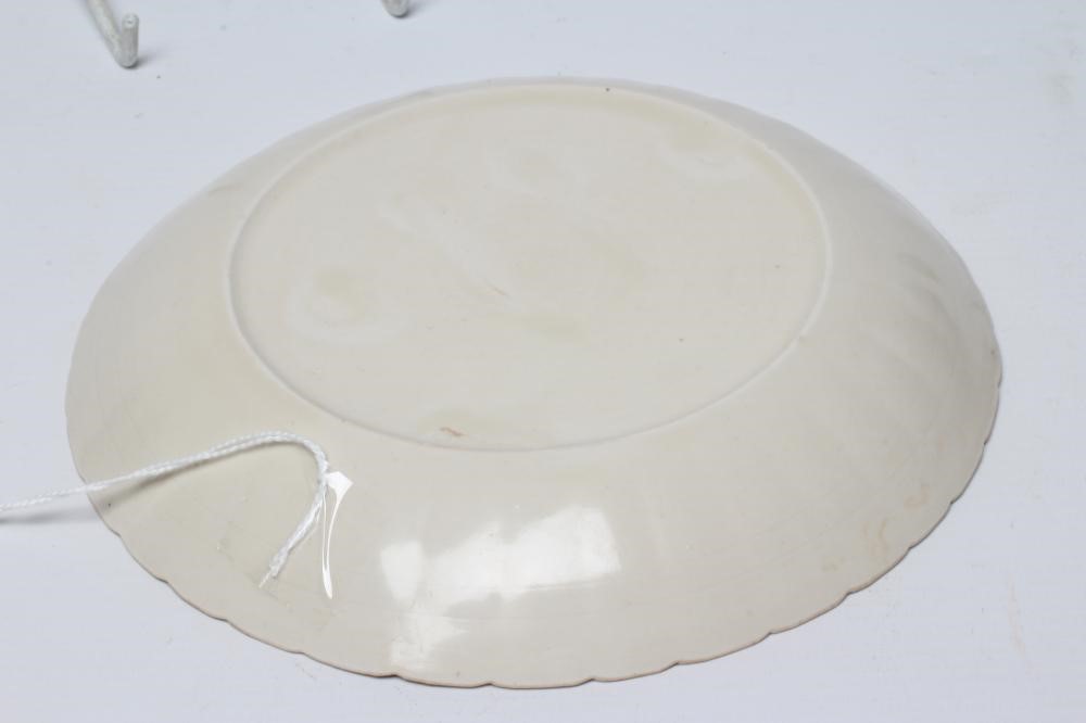 A CHINESE WHITE GLAZED PORCELAIN DISH of fluted circular form centrally carved with a crane in Image