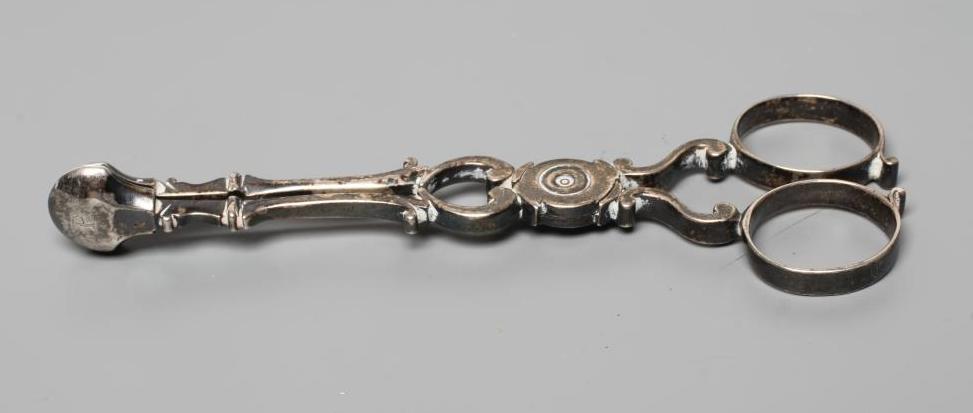 A PAIR OF GEORGE II SILVER SCISSOR SUGAR NIPS, by William Dorrell, no date letter c.1745, the plain Image