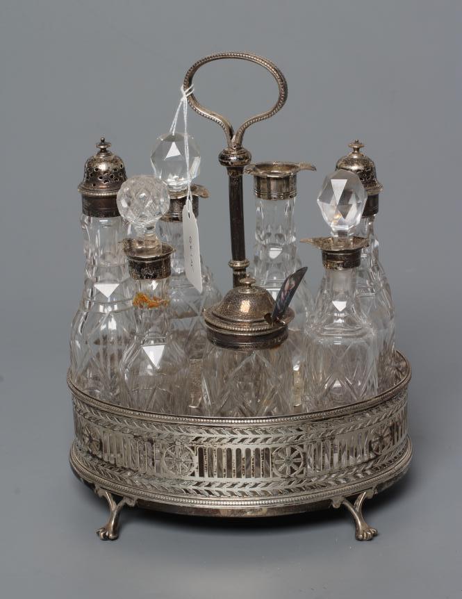 A VICTORIAN SILVER SEVEN BOTTLE CRUET AND OVAL STAND Image