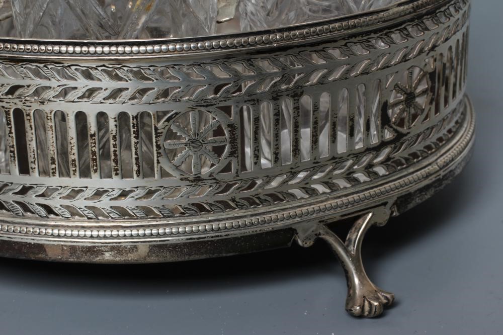 A VICTORIAN SILVER SEVEN BOTTLE CRUET AND OVAL STAND Image