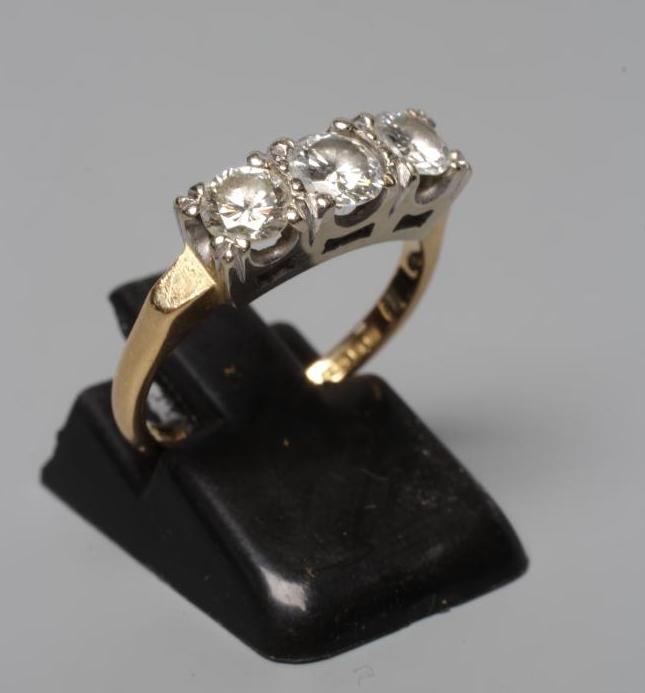 A THREE STONE DIAMOND RING, the round brilliant cut stones each of approximately 0.3cts, claw set to Image