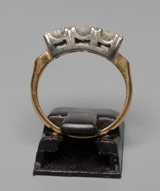 A THREE STONE DIAMOND RING, the round brilliant cut stones each of approximately 0.3cts, claw set to Image