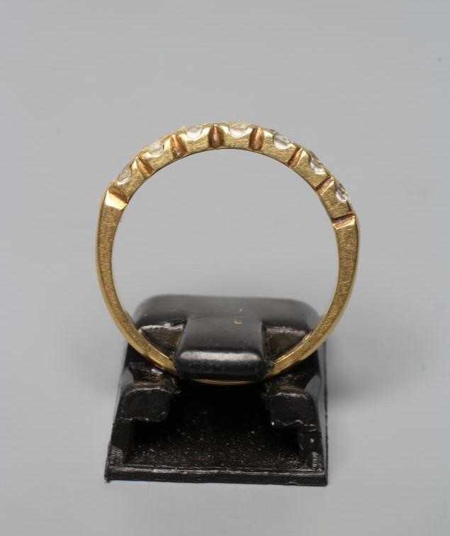 A SEVEN STONE DIAMOND HALF HOOP RING, the brilliant cut stones set to a plain 18ct gold shank, Image