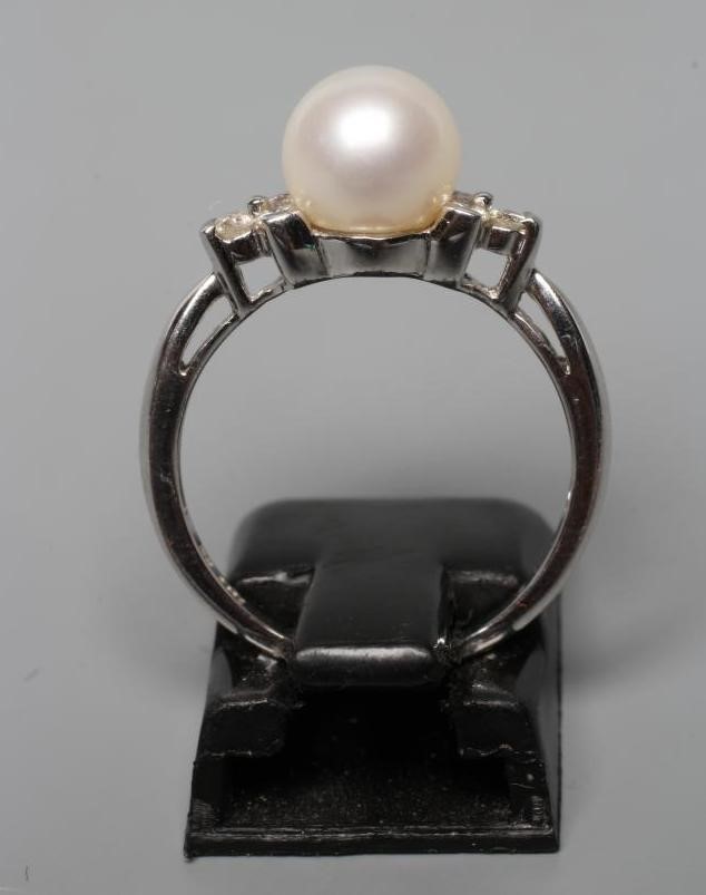 A PEARL AND DIAMOND DRESS RING, the cultured pearl peg set with three small round brilliants to each Image