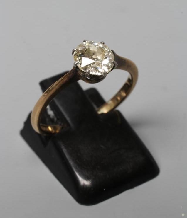 A SOLITAIRE DIAMOND RING, the old cut stone of approximately 1ct, claw set to a plain shank stamped Image