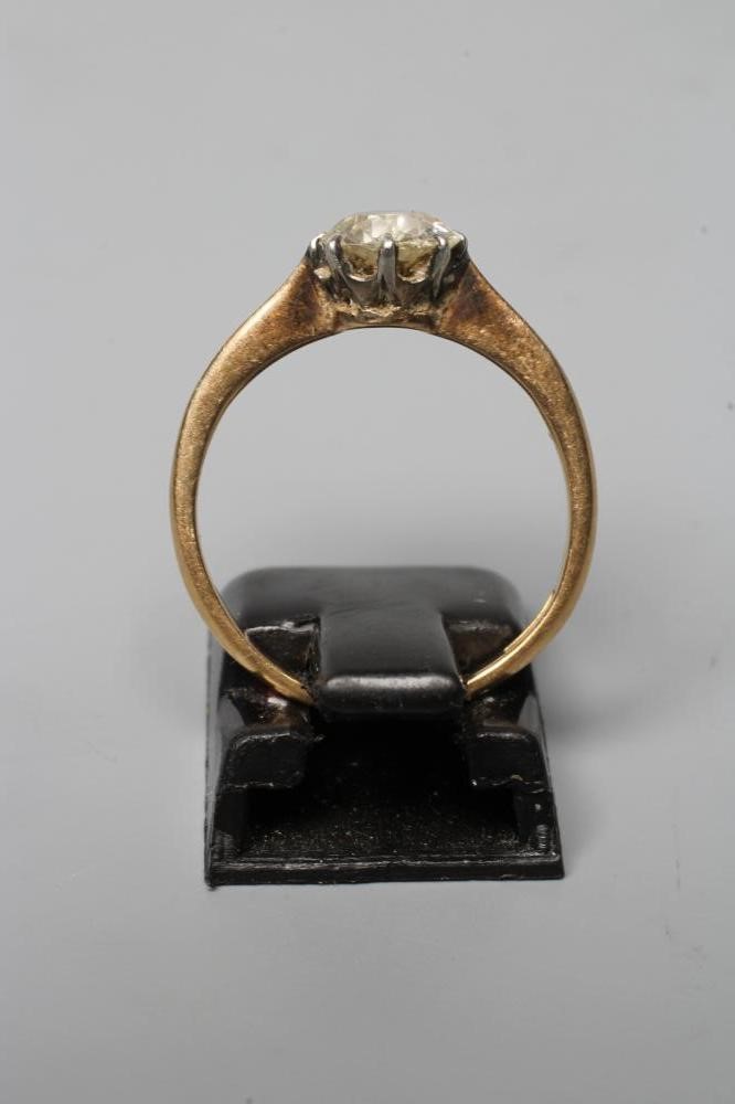 A SOLITAIRE DIAMOND RING, the old cut stone of approximately 1ct, claw set to a plain shank stamped Image