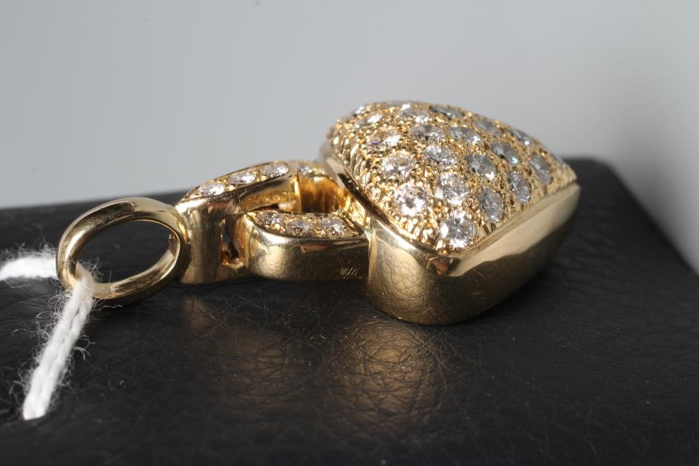 A DIAMOND HEART PADLOCK PENDANT set with numerous small brilliant cut stones to a pointille ground, Image