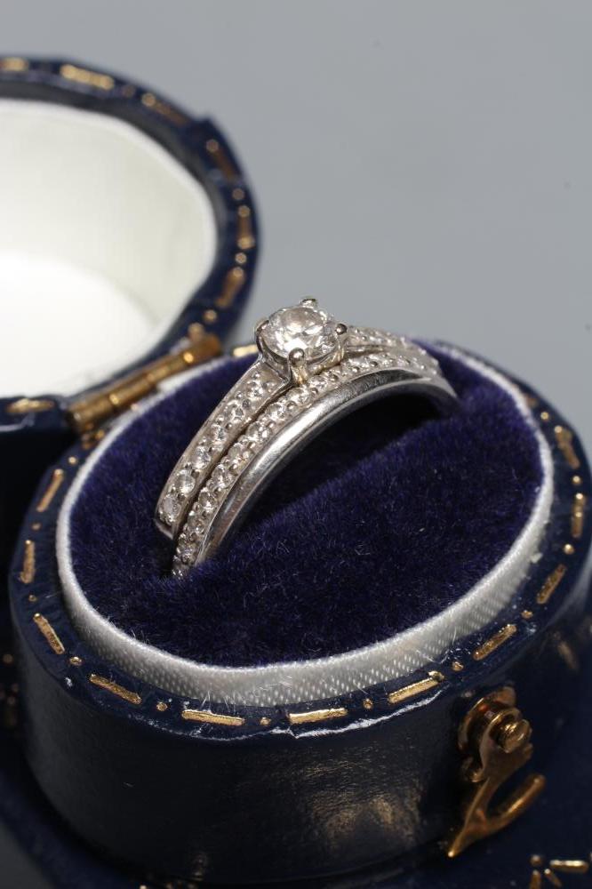A DIAMOND ENGAGEMENT RING WITH MATCHING WEDDING RING Image