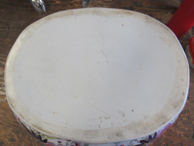 A VICTORIAN EARTHENWARE FOOTBATH of lobed bombe rounded oblong form with two scroll handles Image