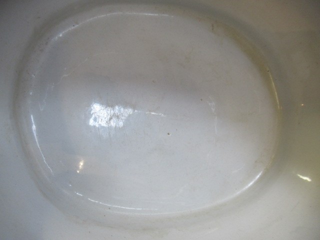 A VICTORIAN EARTHENWARE FOOTBATH of lobed bombe rounded oblong form with two scroll handles Image