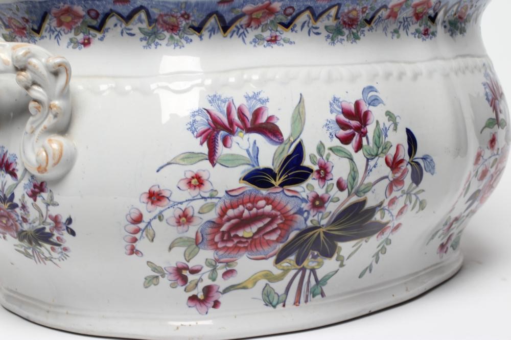 A VICTORIAN EARTHENWARE FOOTBATH of lobed bombe rounded oblong form with two scroll handles Image