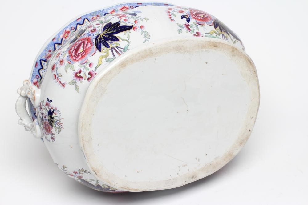 A VICTORIAN EARTHENWARE FOOTBATH of lobed bombe rounded oblong form with two scroll handles Image