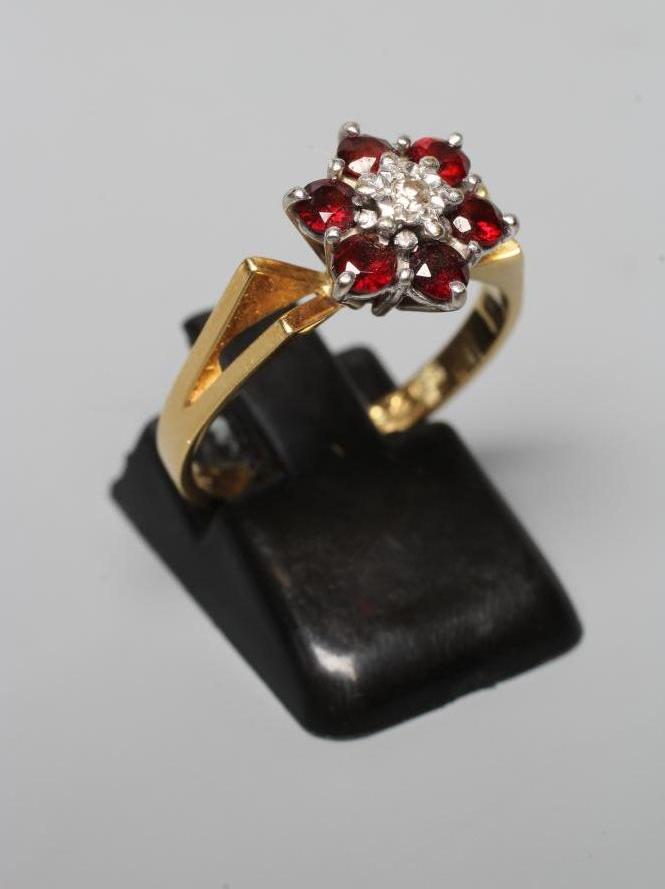 A GARNET AND DIAMOND CLUSTER RING Image