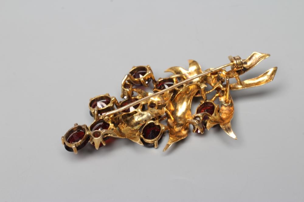 A VICTORIAN STYLE GARNET SPRAY BROOCH with fifteen various cut and sized stones claw set to a leaf Image