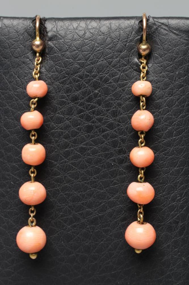 A PAIR OF EDWARDIAN CORAL EAR BOBS, the five graduated polished spheres pendant from unmarked Image