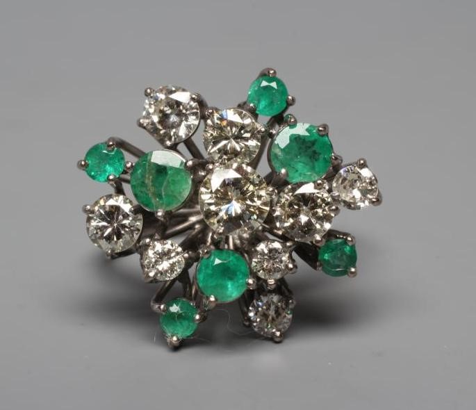 AN EMERALD AND DIAMOND COCKTAIL RING, the nine diamonds and seven emeralds of varying sizes claw set Image