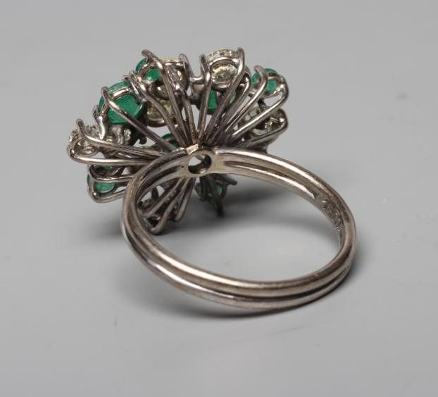 AN EMERALD AND DIAMOND COCKTAIL RING, the nine diamonds and seven emeralds of varying sizes claw set Image