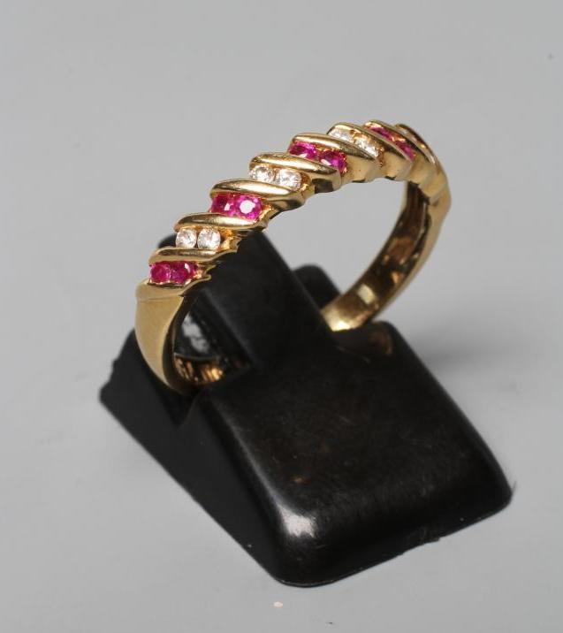 A RUBY AND DIAMOND HALF HOOP RING, the five pairs of rubies and four pairs of small brilliants Image