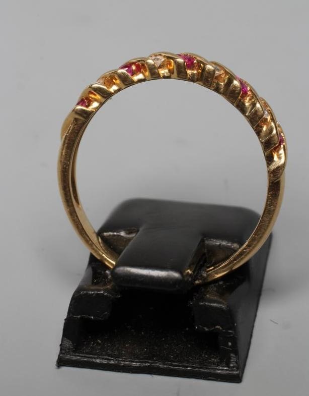 A RUBY AND DIAMOND HALF HOOP RING, the five pairs of rubies and four pairs of small brilliants Image