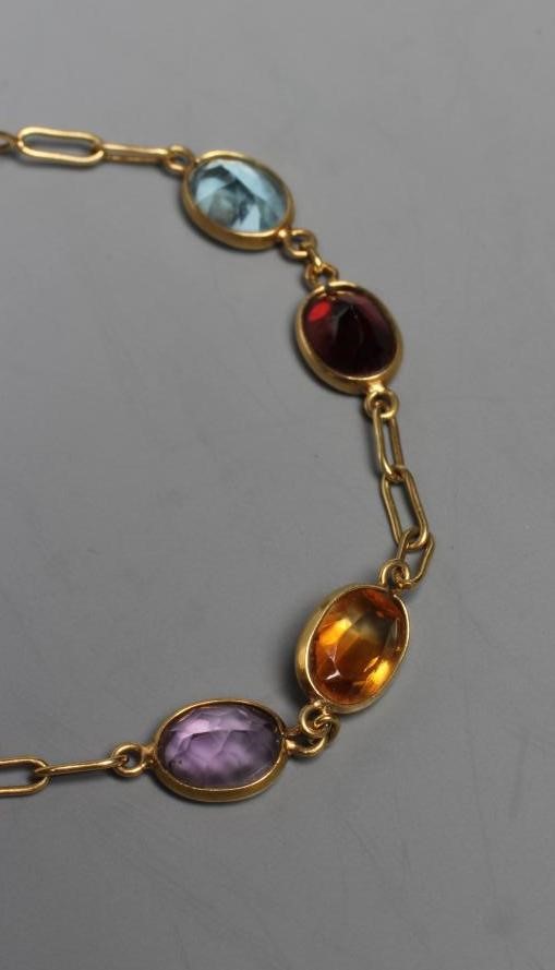 A MULTI-GEM BRACELET, the four pairs of facet cut coloured stones including garnet, aquamarine and Image