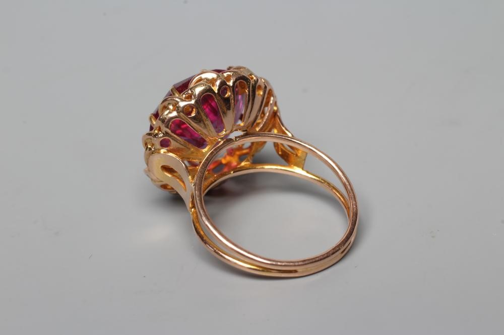 AN ALEXANDRITE DRESS RING, the circular facet cut stone claw set to a twist mount, open shoulders Image