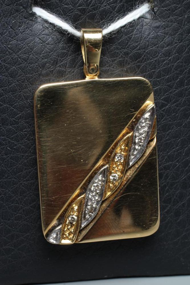 AN 18CT GOLD PENDANT of rounded oblong form with an asymetric 'twist' detail point set with six Image